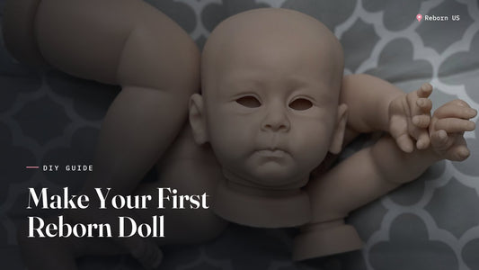 Unpainted silicone reborn doll kit with head, arms and legs laid out on a grey patterned blanket, ready to make a reborn doll